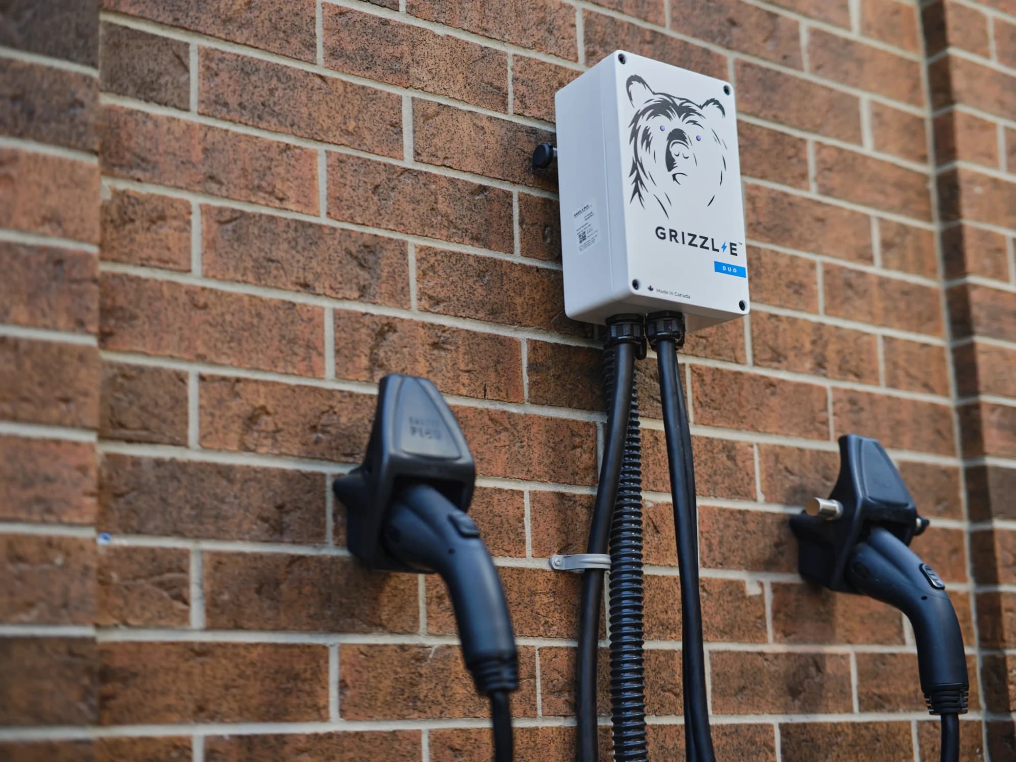Grizzl-E Duo EV charger mounted on a brick wall